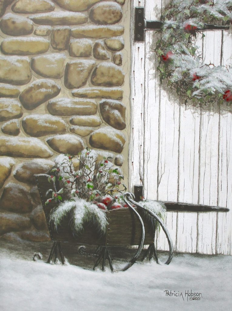 A tiny sleigh filled with greenery and apples sitting in the snow by a rock building with a wreath on the old door.