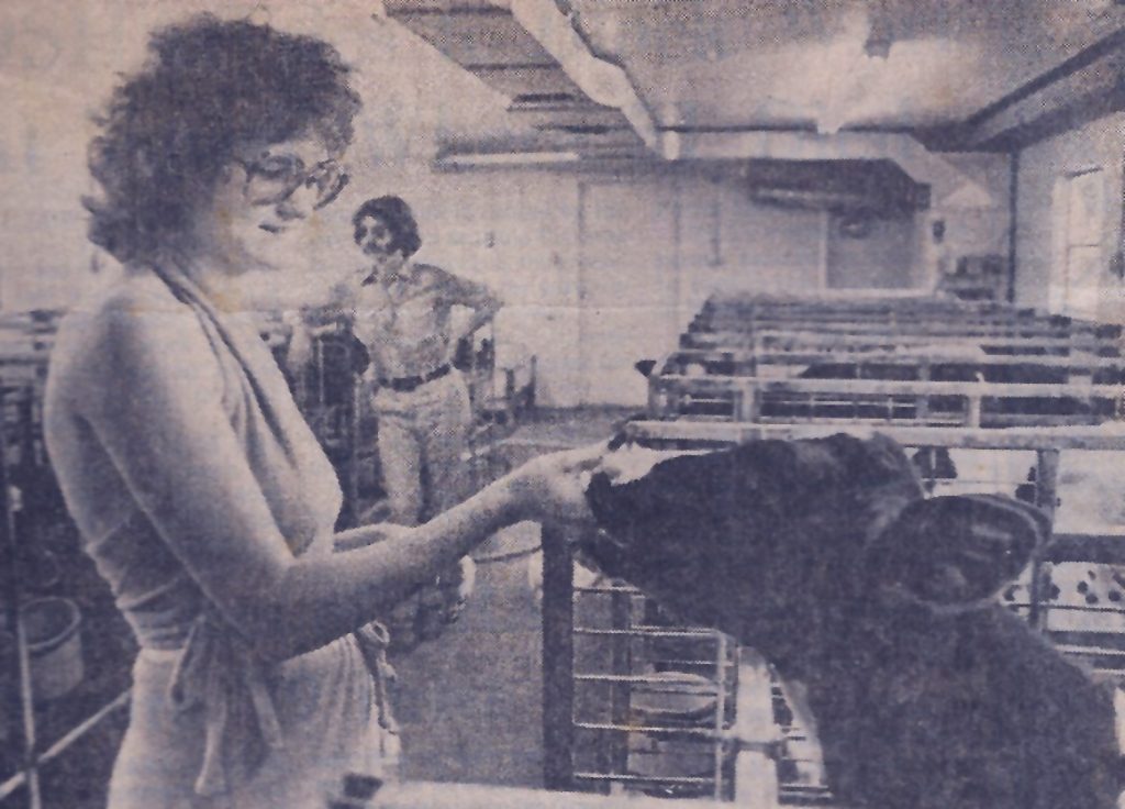 Patricia Hobson caring for the calves on the farm.